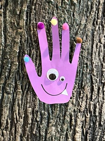 Attached is a demo picture of the Children's Library model of a monster hand using materials such as construction paper (traced from a hand shape), googly eyes, pom poms, etc. 