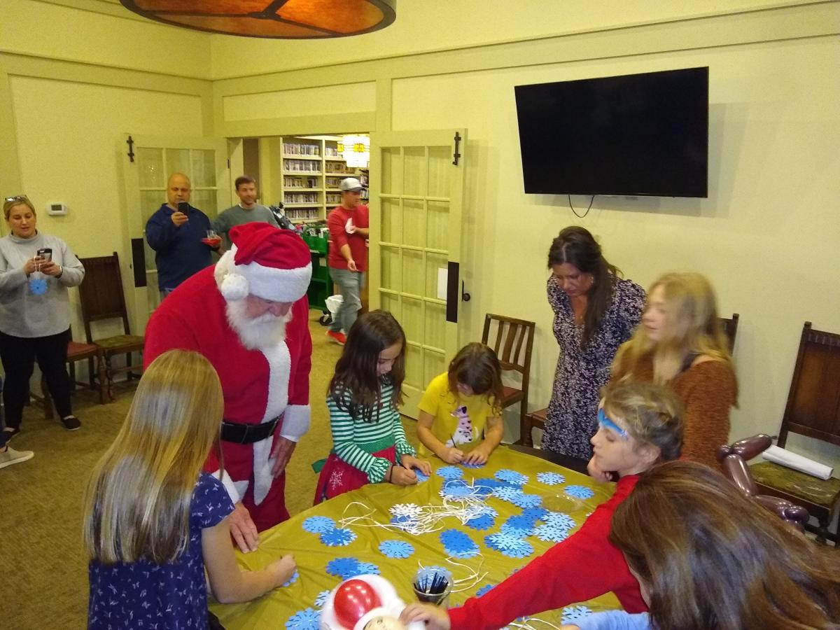 Santa and kids doing a craft